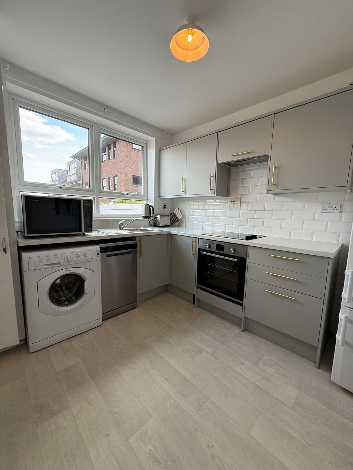 Kitchen worktop and appliance surfaces degreased and wiped down