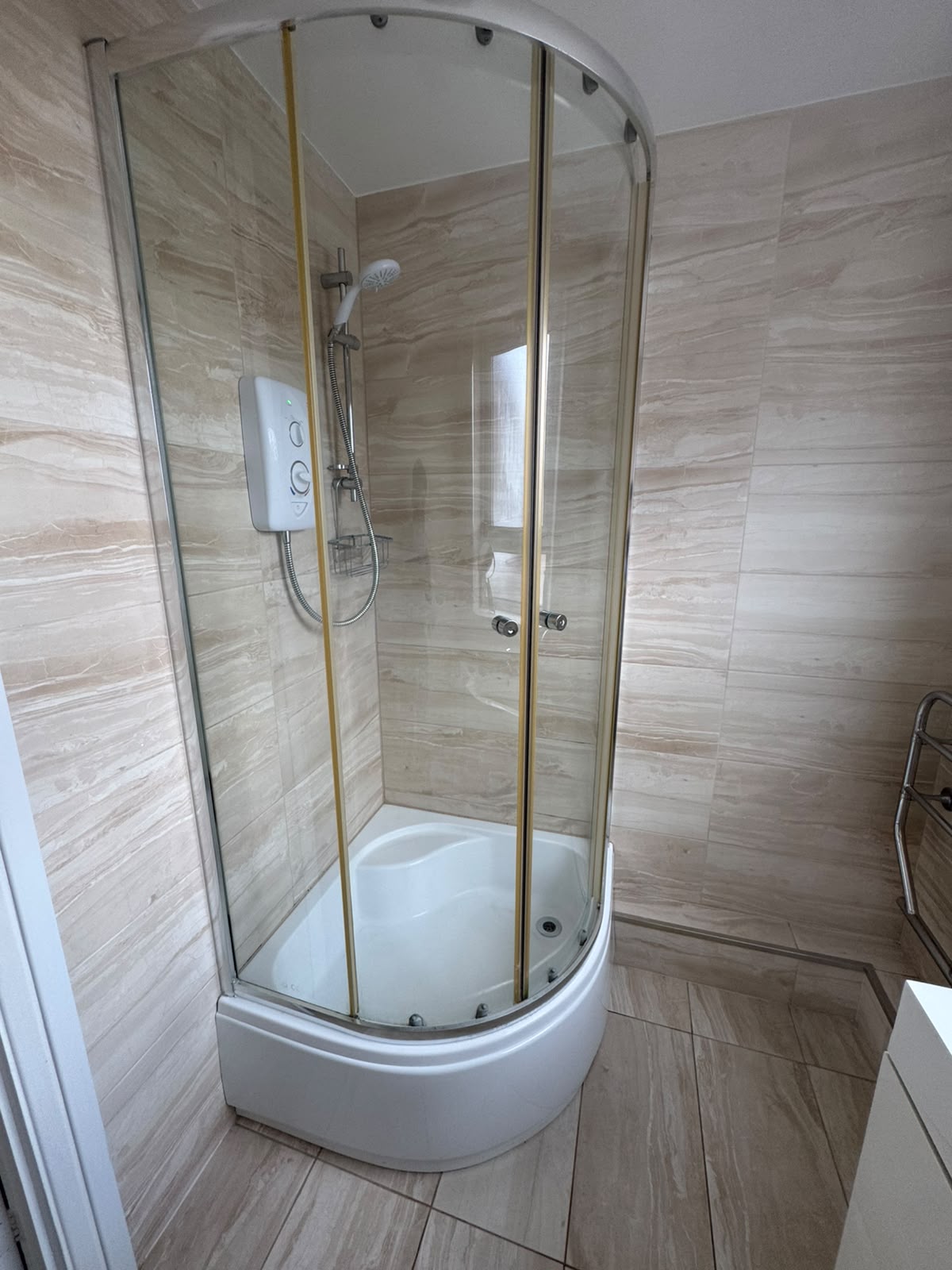 Descaled shower screen and tiling after a bathroom deep clean